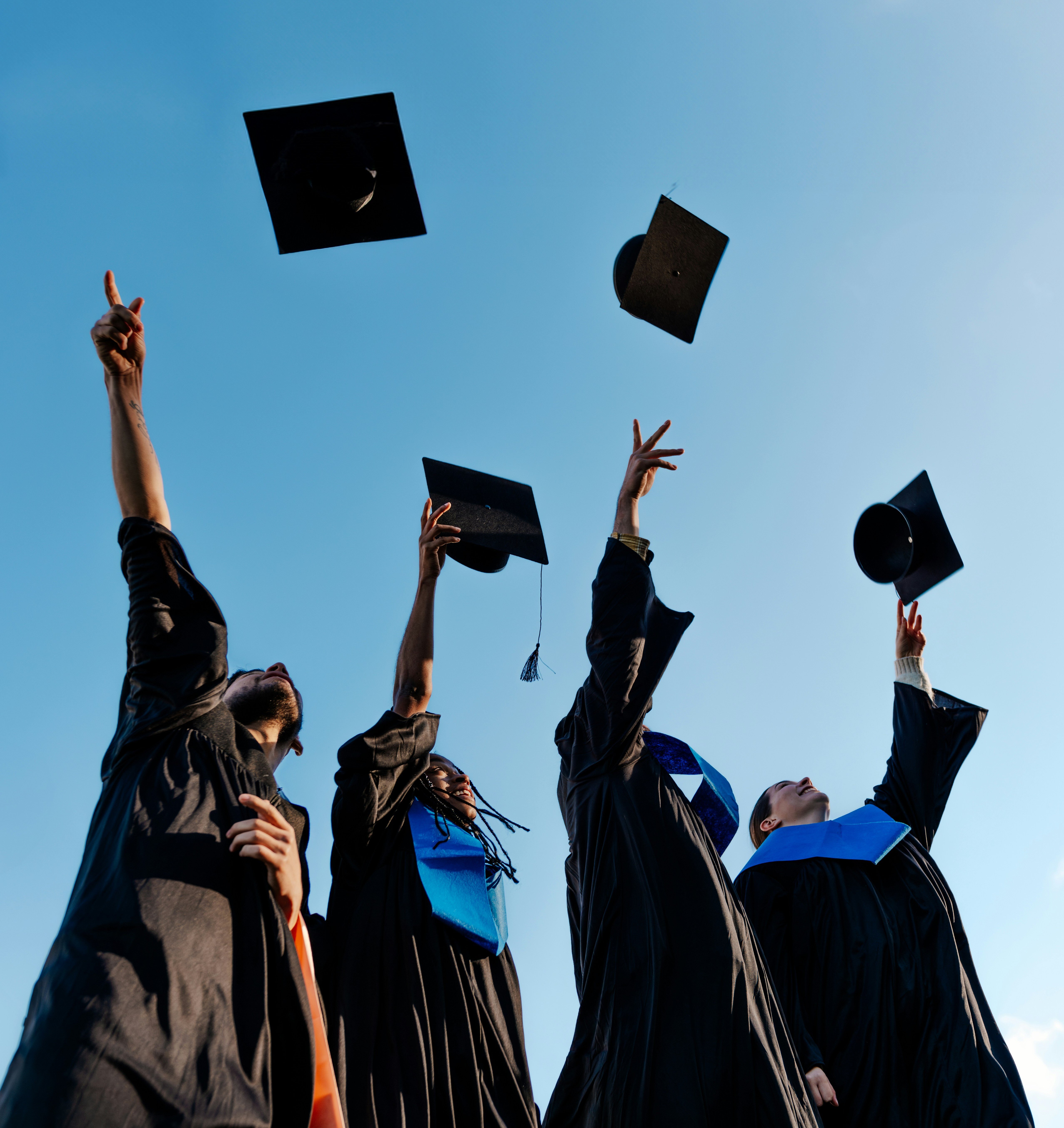 Graduates throw their caps in celebration