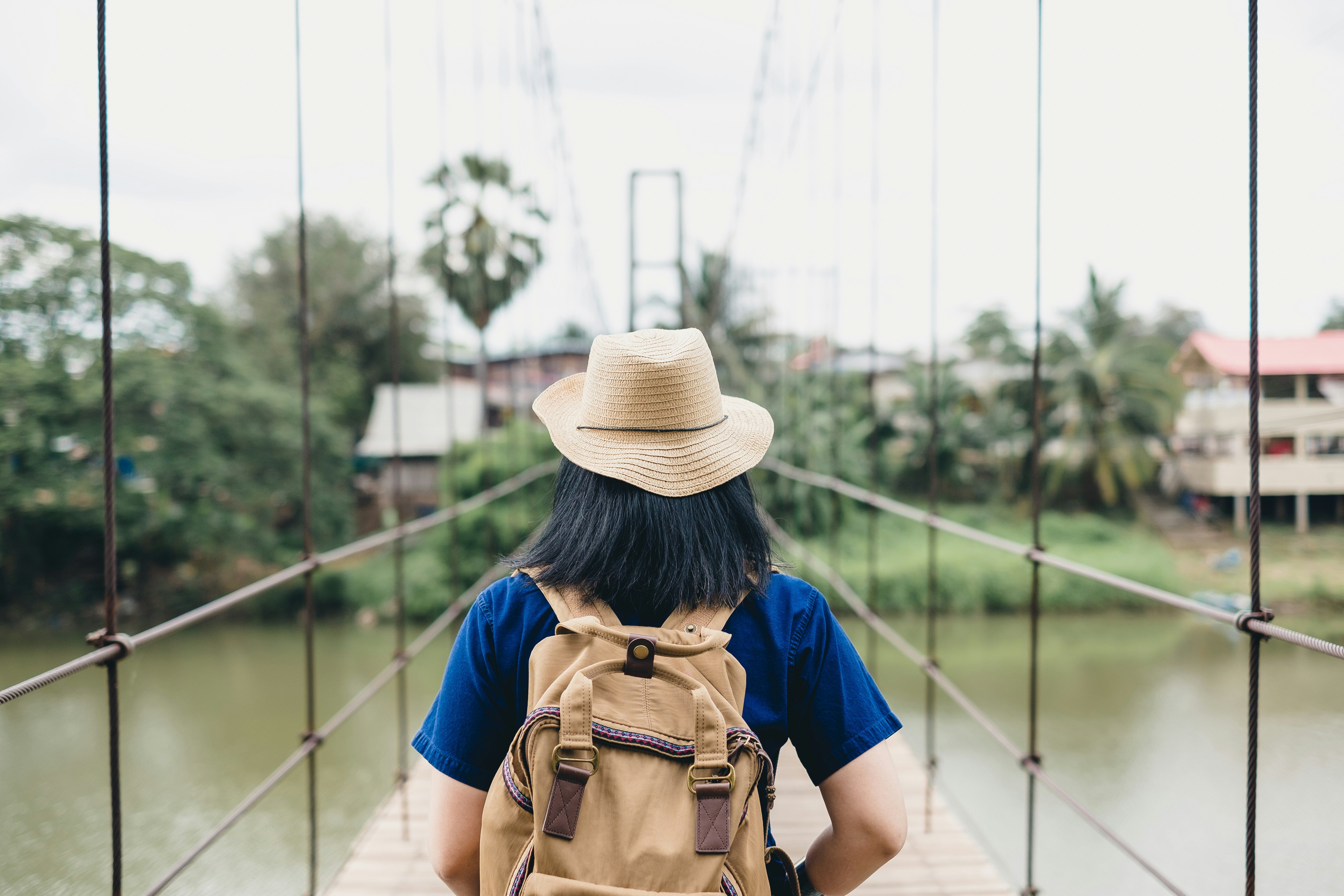 Young woman ready to adventure across a footbridge